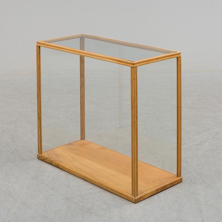 a mid 20th century oak and glass cabinet.