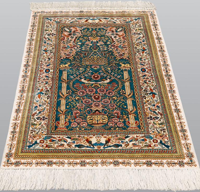 A pictorial oriental silk rug, ca 121 x 77 cm.