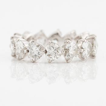 A Graff platinum eternity band set with heart shaped diamonds.