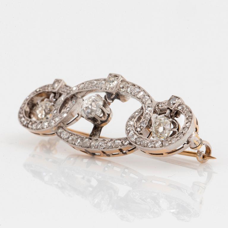 A platinum and gold brooch set with old- and rose-cut diamonds.