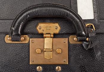 HERMÈS, a black leather suitcase from the 1950/60s.