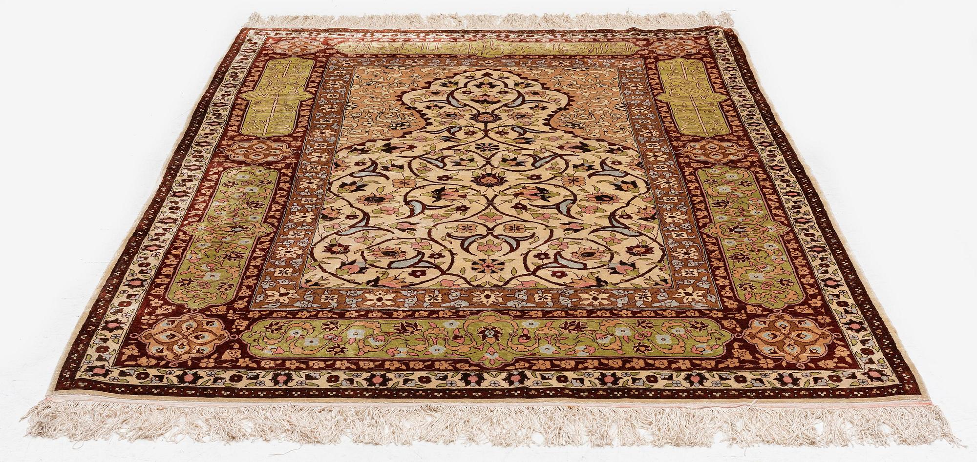 A semi-antique Turkish silk rug, c. 200 x 130 cm.