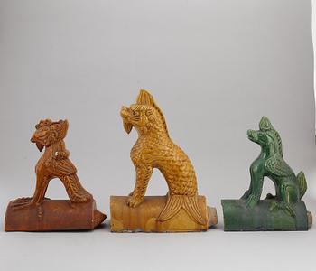 A group of three Chinese glazed roof tiles of seated animals, 20th century.