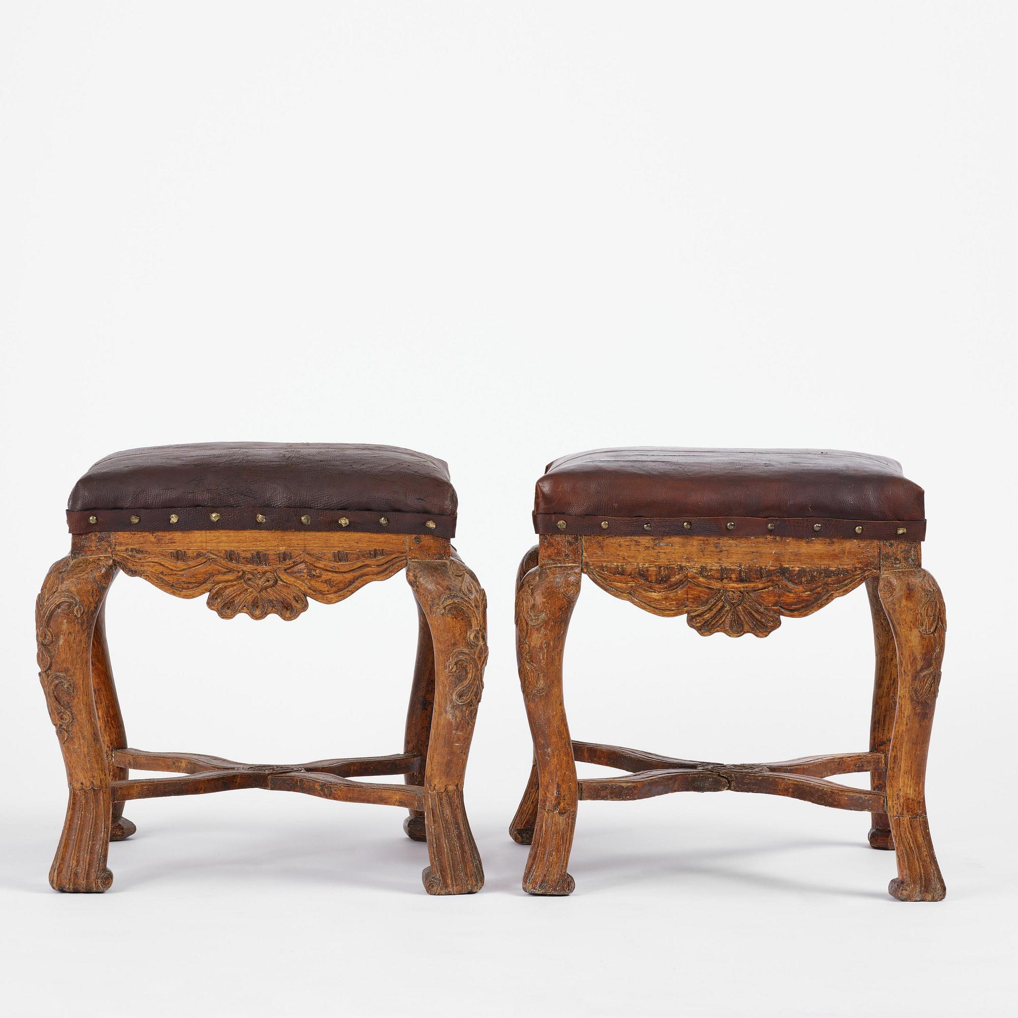 A pair of carved stools in the manner of Jonas Granberg, Jämtland, Sweden, mid 18th century.