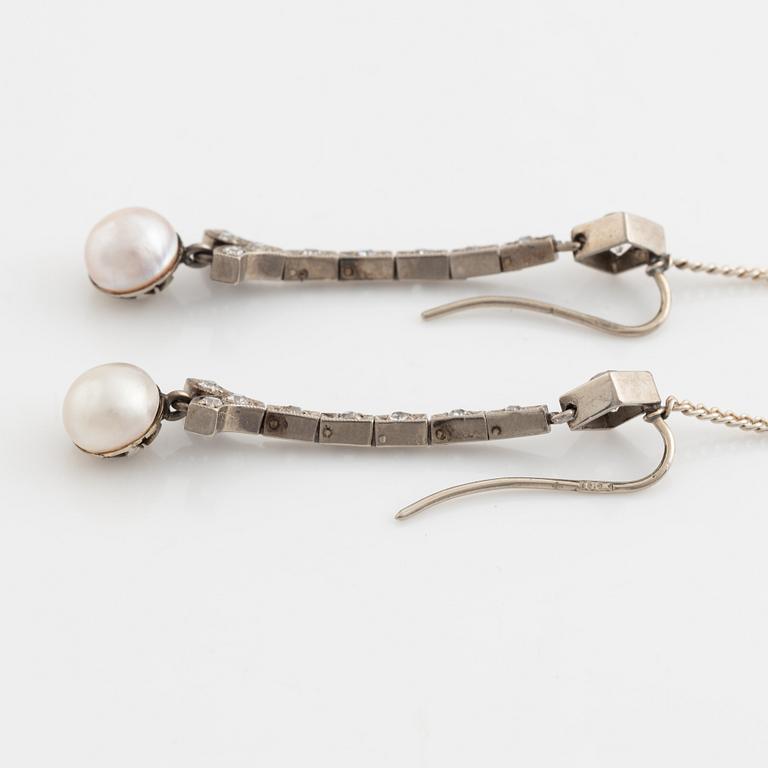 A pair of 18K gold and cultured halfpearl and diamond earrings.