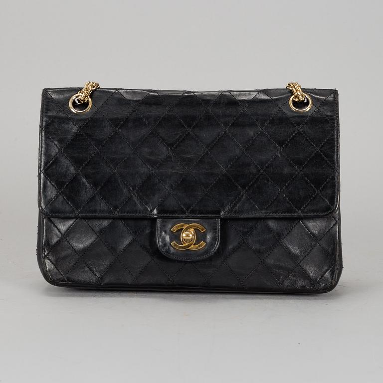CHANEL, a quilted black leather 'Double Flap Bag'.