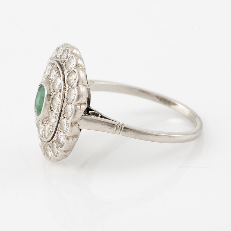 Platinum ring with an emerald and brilliant-cut diamonds.