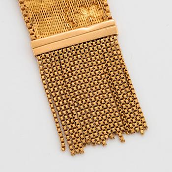An 18K gold bracelet set with rubies.