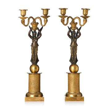 241. A pair of gilt and patinated bronze Empire-style two branch candelabra, later part 18th century.