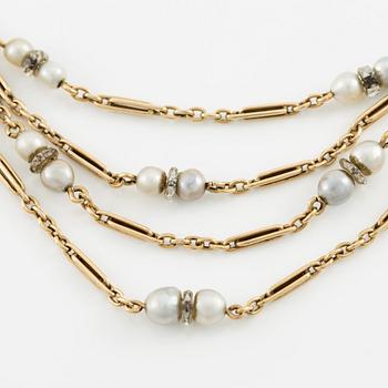 A W.A. Bolin necklace in 18K gold with pearls and white discs.