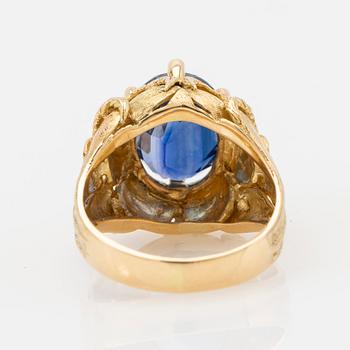 Ring, 18k gold with blue stone, possibly sapphire.