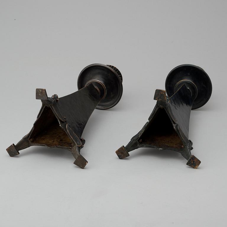 A pair of Melchior Wernstedt patinated bronze candlesticks, by Herman Bergman, Stockholm 1925.