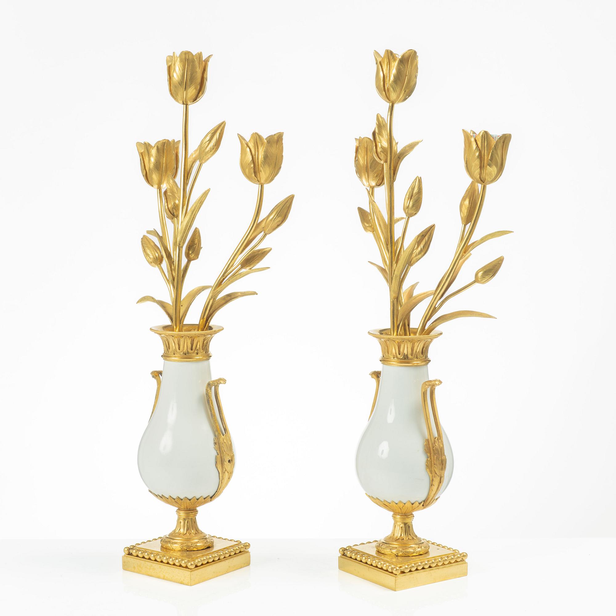 A pair of three light porcelain and gilt bronze three-branch Louis XV-style candelabra, mid 19th century.