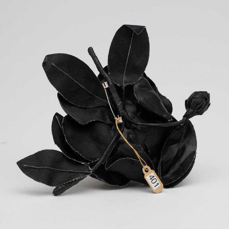 YVES SAINT LAURENT, a black brooch.