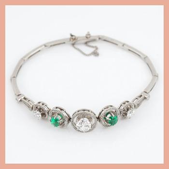 ARMBAND med briljantslipade diamanter totalt ca 1.50 ct (äldre slipning) samt smaragder.