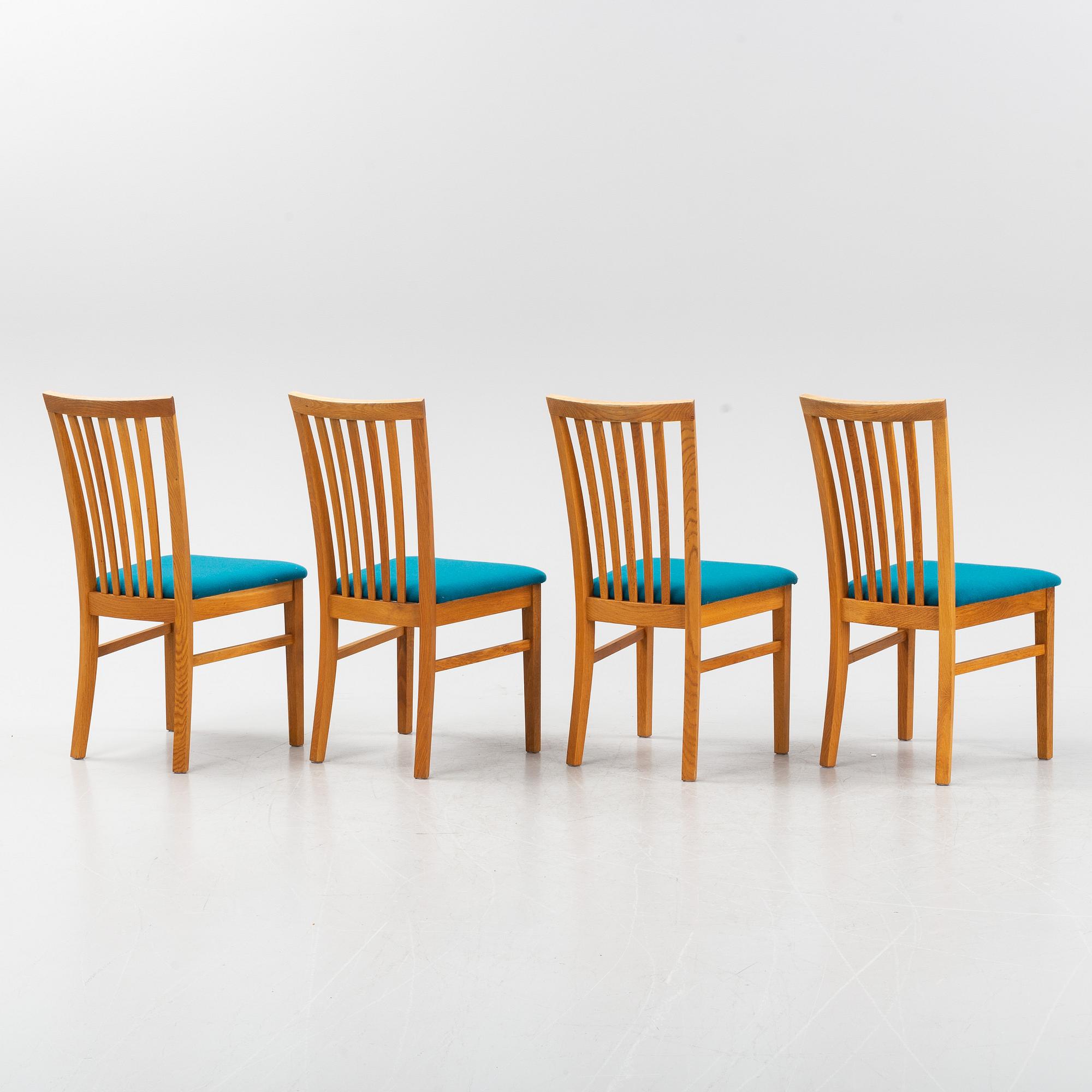 A set of four oak chairs from around the year 2000.