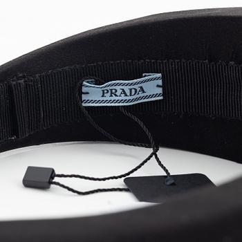 Prada, a black silk hair accessory.