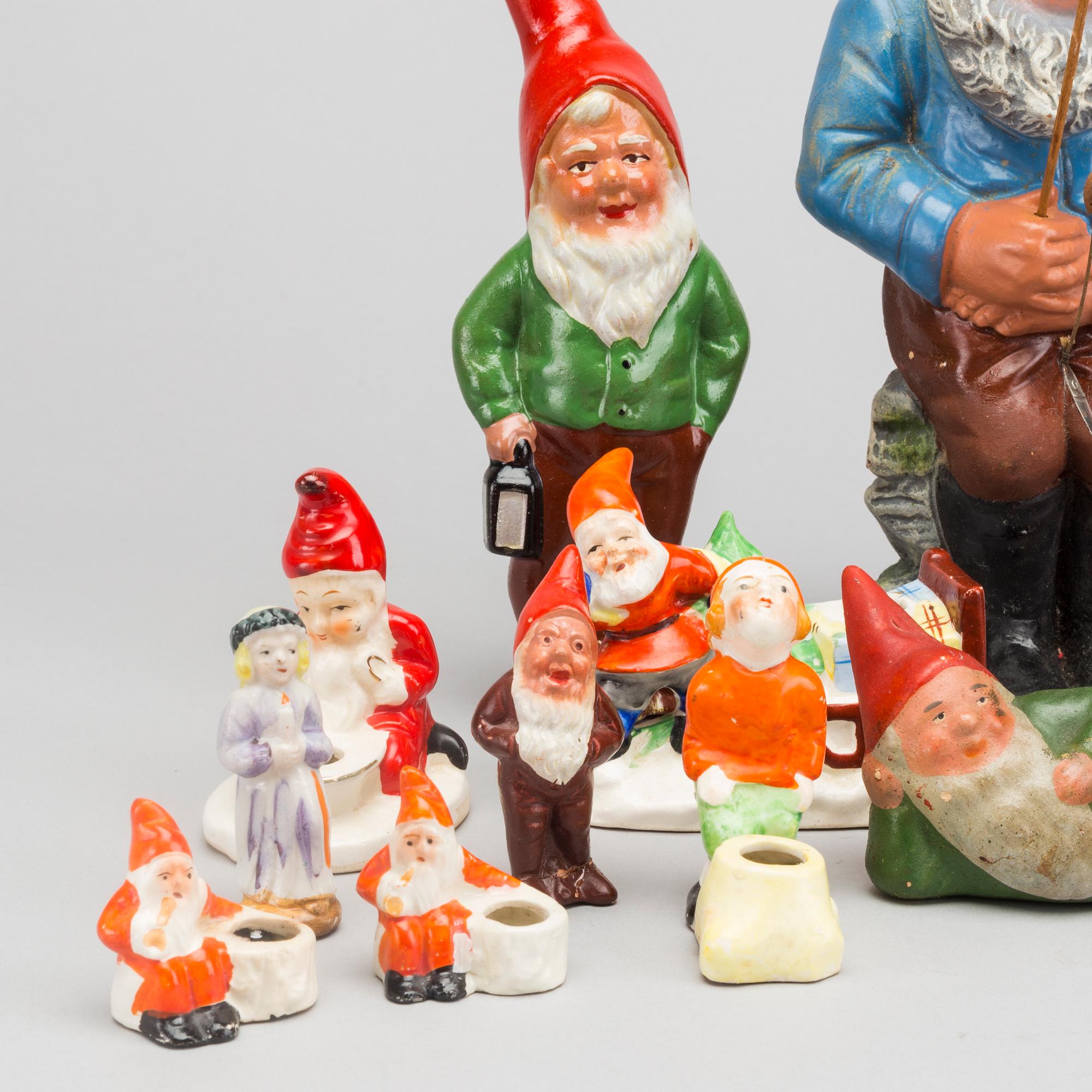 18 porcelain and pottery figurines and candleholders. First half of the 20th cetnury.