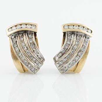 Gold earrings with brilliant-cut and octagon-cut diamonds.