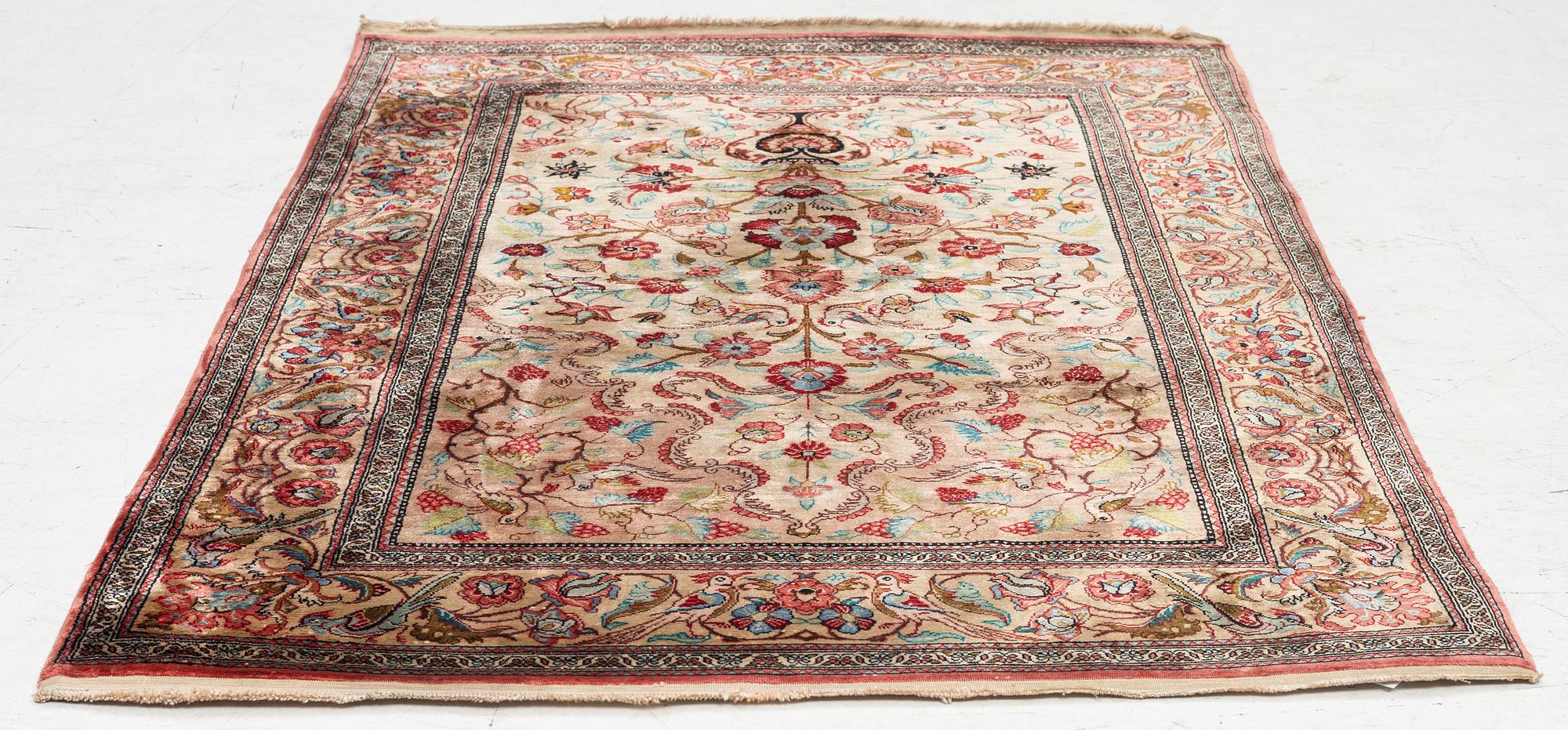 A Qum silk rug, c. 110 x 76 cm.