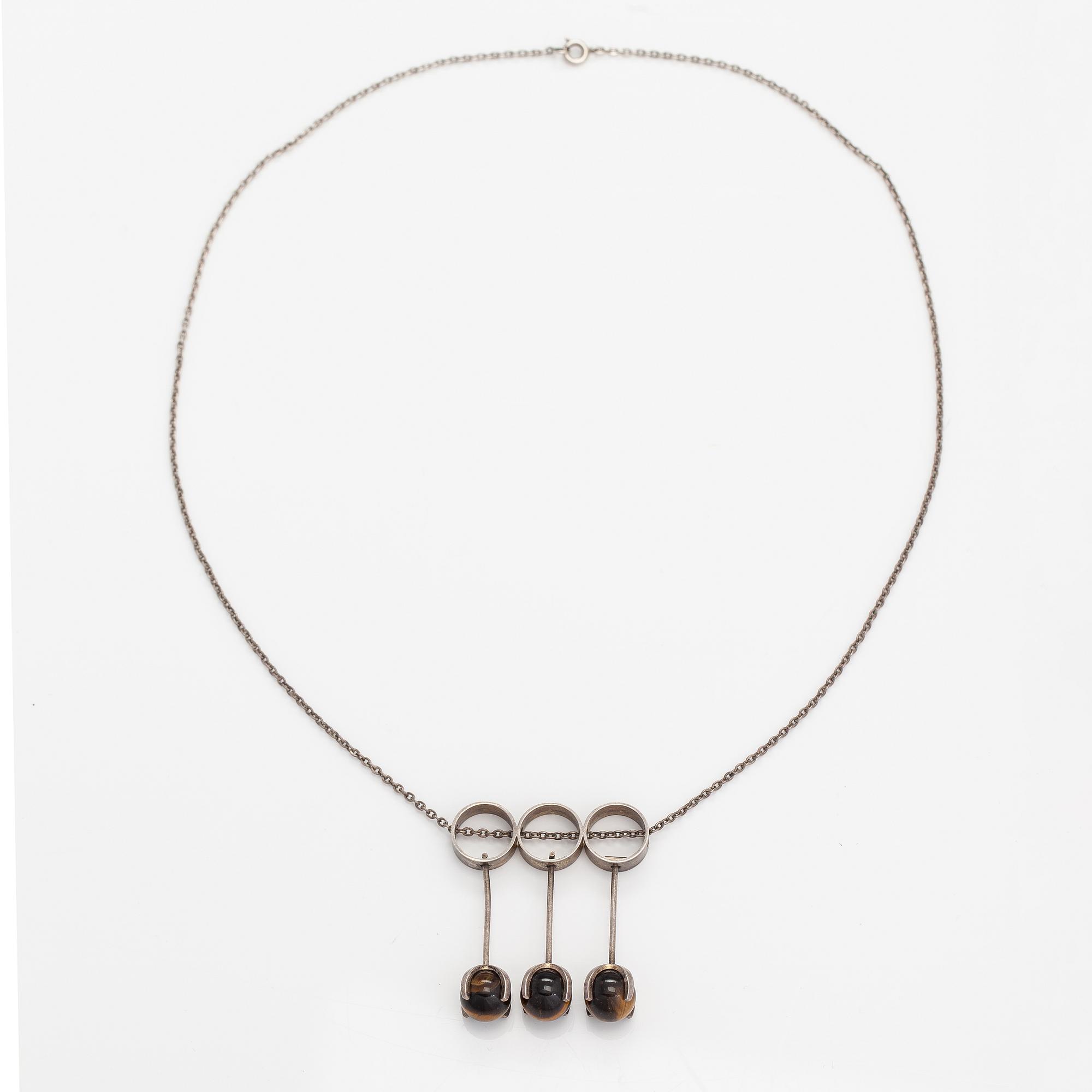 Elis Kauppi, A silver necklace with tiger's eye pearls. Kupittaan kulta, Turku 1965.