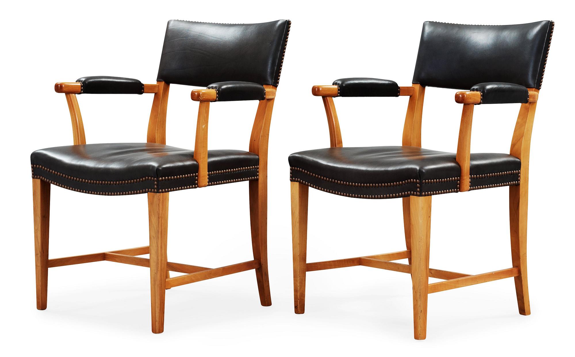 A pair of Josef Frank walnut and black leather armchairs, Svenskt Tenn, model 695.