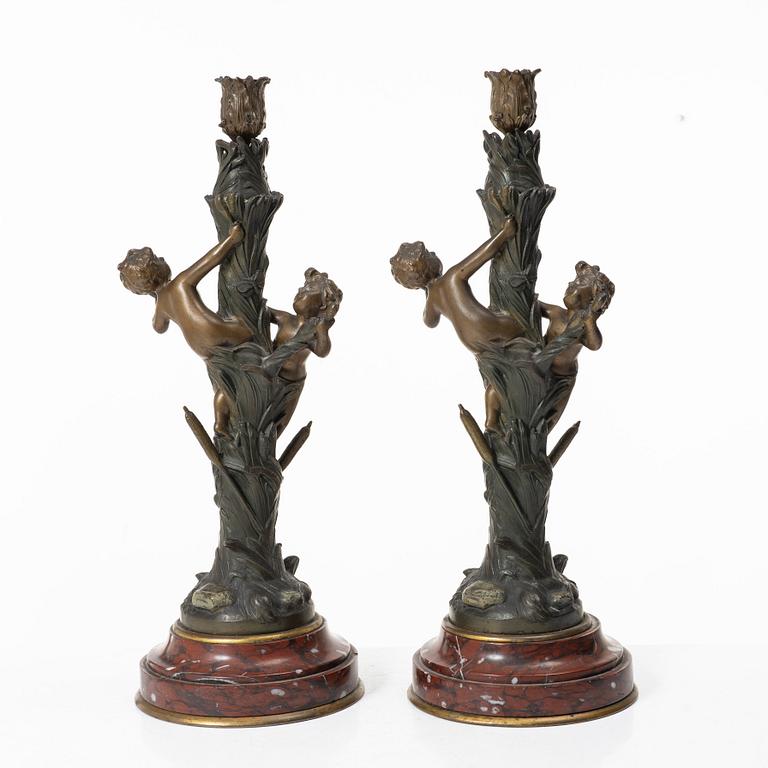 a pair of bronze and marble candle sticks, after a model by Houdon, late 19th century.