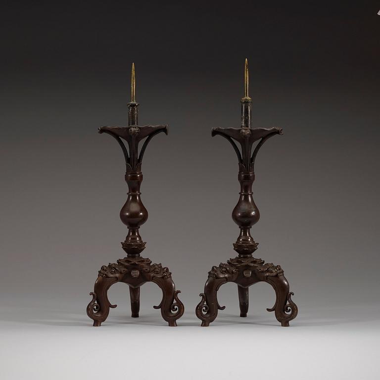 A pair of bronze candlesticks, presumably Ming dynasty (1368-1644).