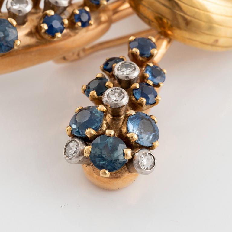 An 18K gold WA Bolin brooch set with faceted sapphires and eight-cut diamonds.