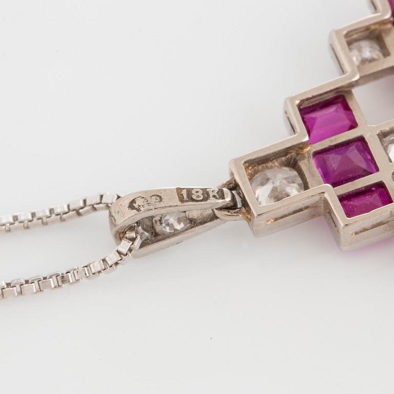 An 18K white gold pendant set with step-cut rubies and old-cut dimonds.