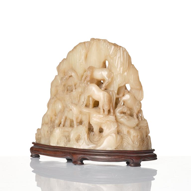 A carved Chinese soapstone bolder with Wang Mu's eight horses, 20th Century.