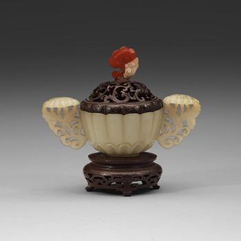 20. A nephrite cup with wooden cover and stand with silver inlay and quartz finial, Qing dynasty, 19th Century.