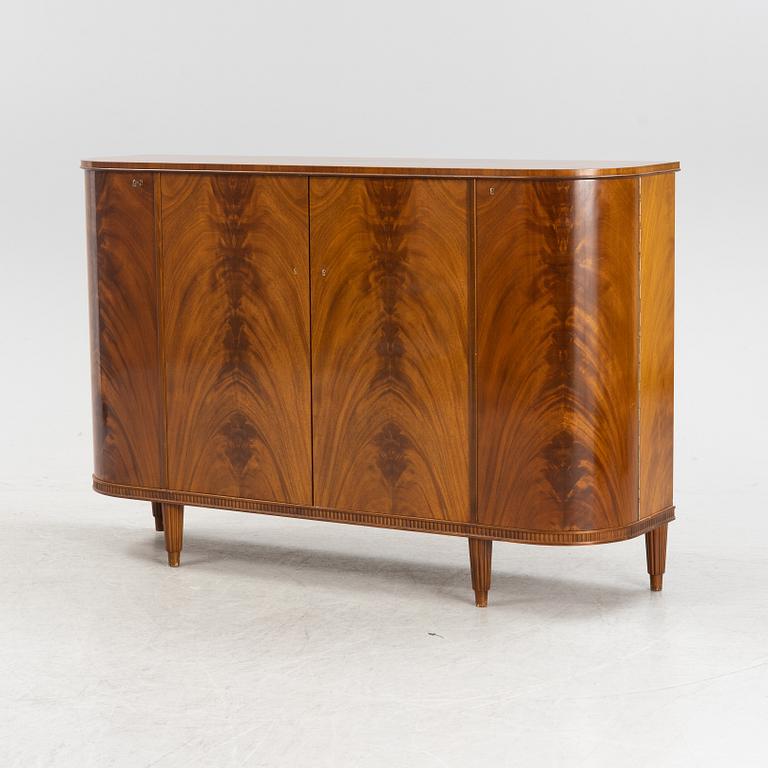 A 1940s mahogany veneered cabinet.