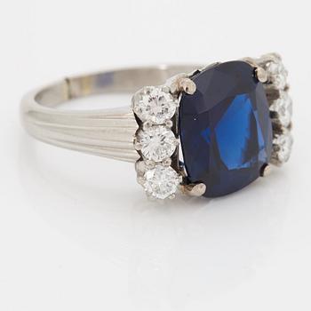 A RING set with a faceted sapphire.