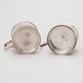 Two tea glass holders in silver, one with mark of Ivan Saltykov, Moscow 1889, the other one marked Moscow 1908-1917.