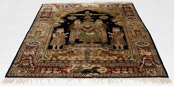 A pictorial semi-antique silk Qum rug, central Persia, c. 214 x 146 cm.