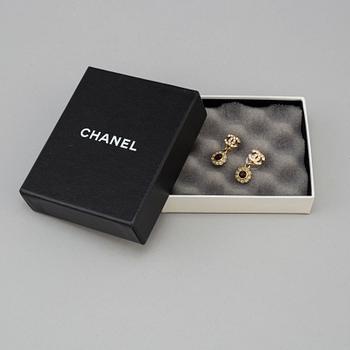 Apair of Chanel golden earrings with white and red stones, 2006.