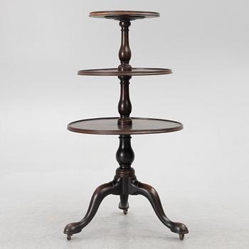 A mahogany three-tier table, England, circa 1900.