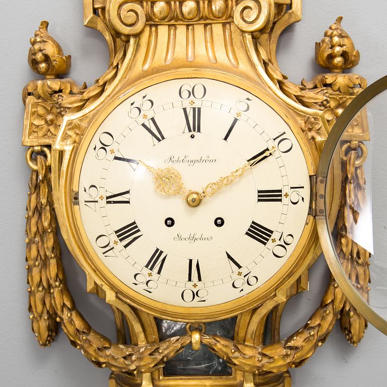 A wall clock in gustavian style, marked Rob. Engström, Stockholm.