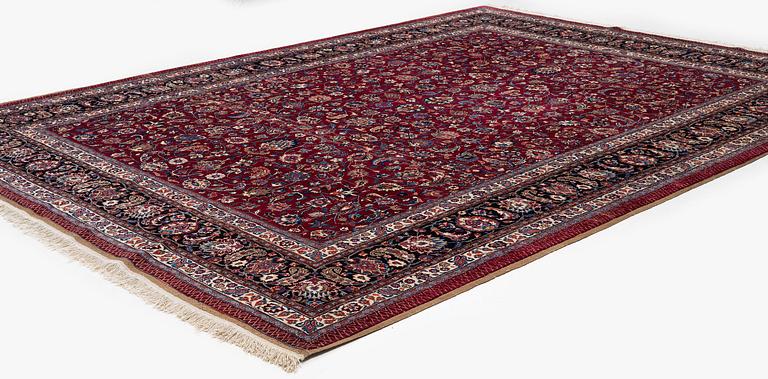 A Mashad carpet, signed Saber, c. 402 x 299 cm.