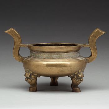 A large brass tripod censer, Qing dynasty (1644-1912).