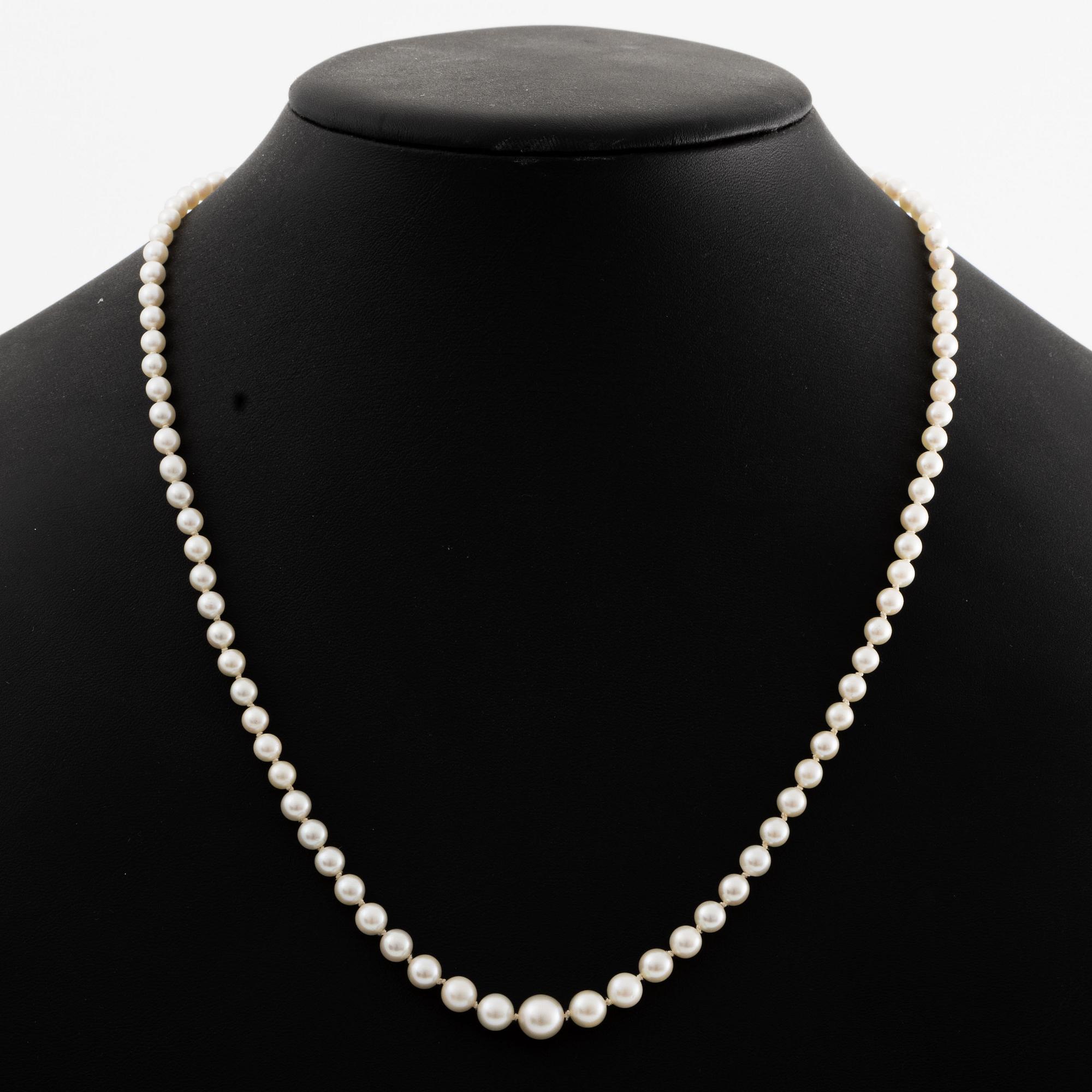 A necklace of cultured pearls clasp with old-cut diamonds.
