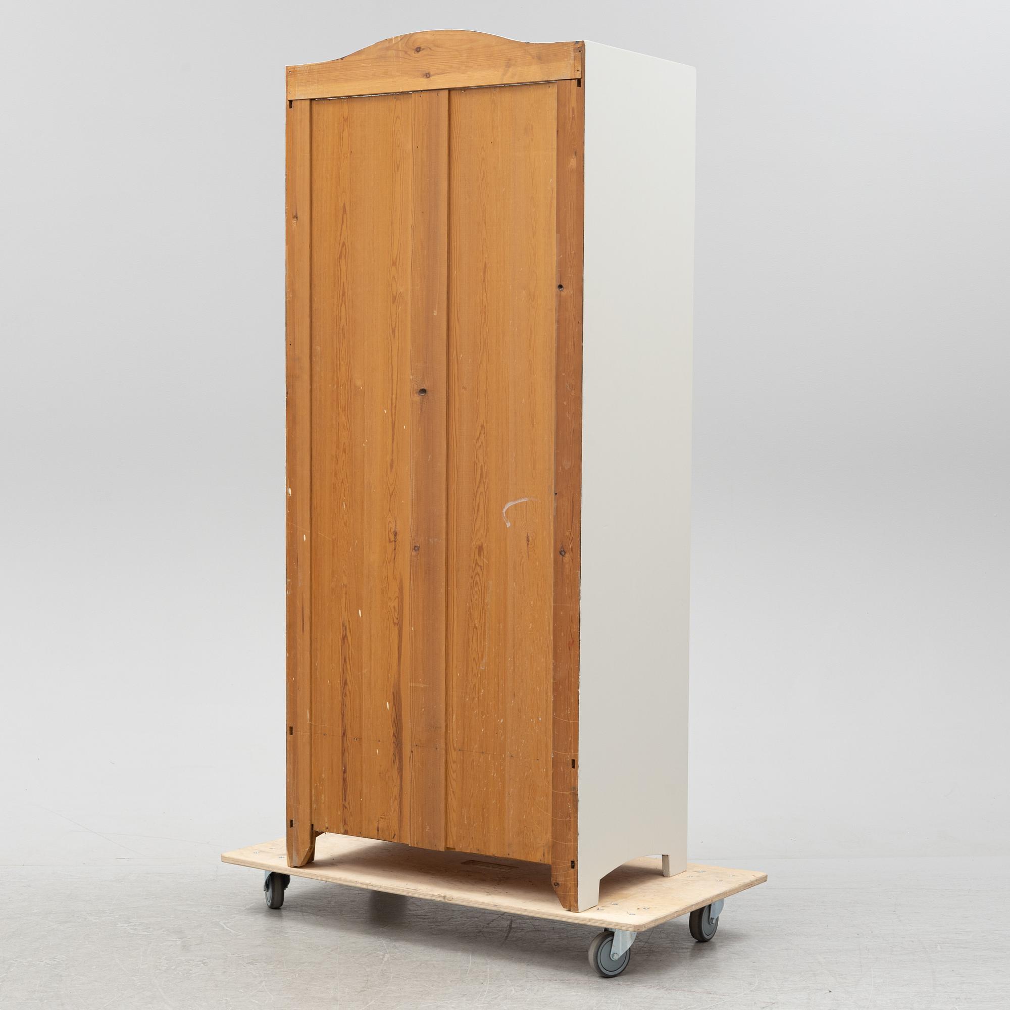 An early 20th Century painted clothes cabinet.