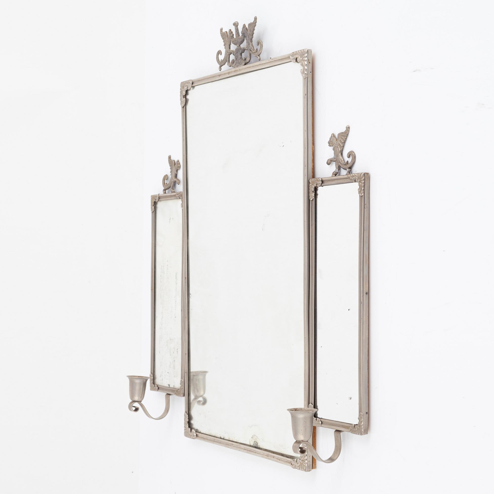 A Swedish Grace mirror and a pair of wall sconces, 1920's/30's.