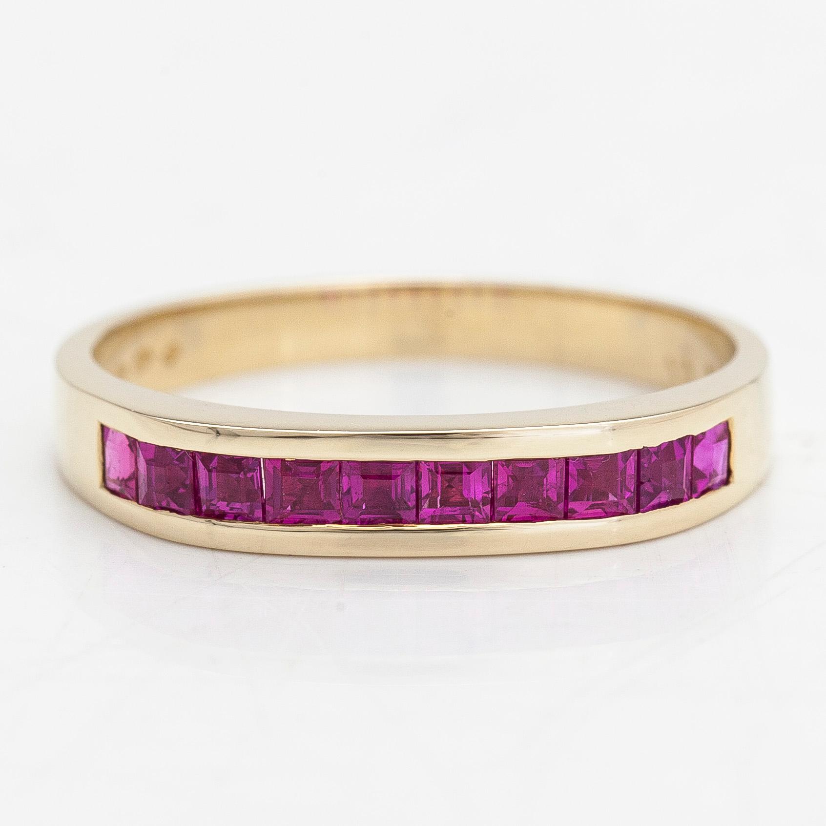A 14K half eternity gold ring, with rubies.