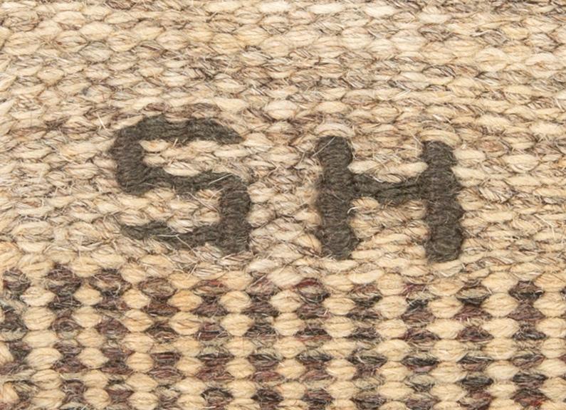 A Swedish flat weave carpet signed SH ca 243 x 162 cm.