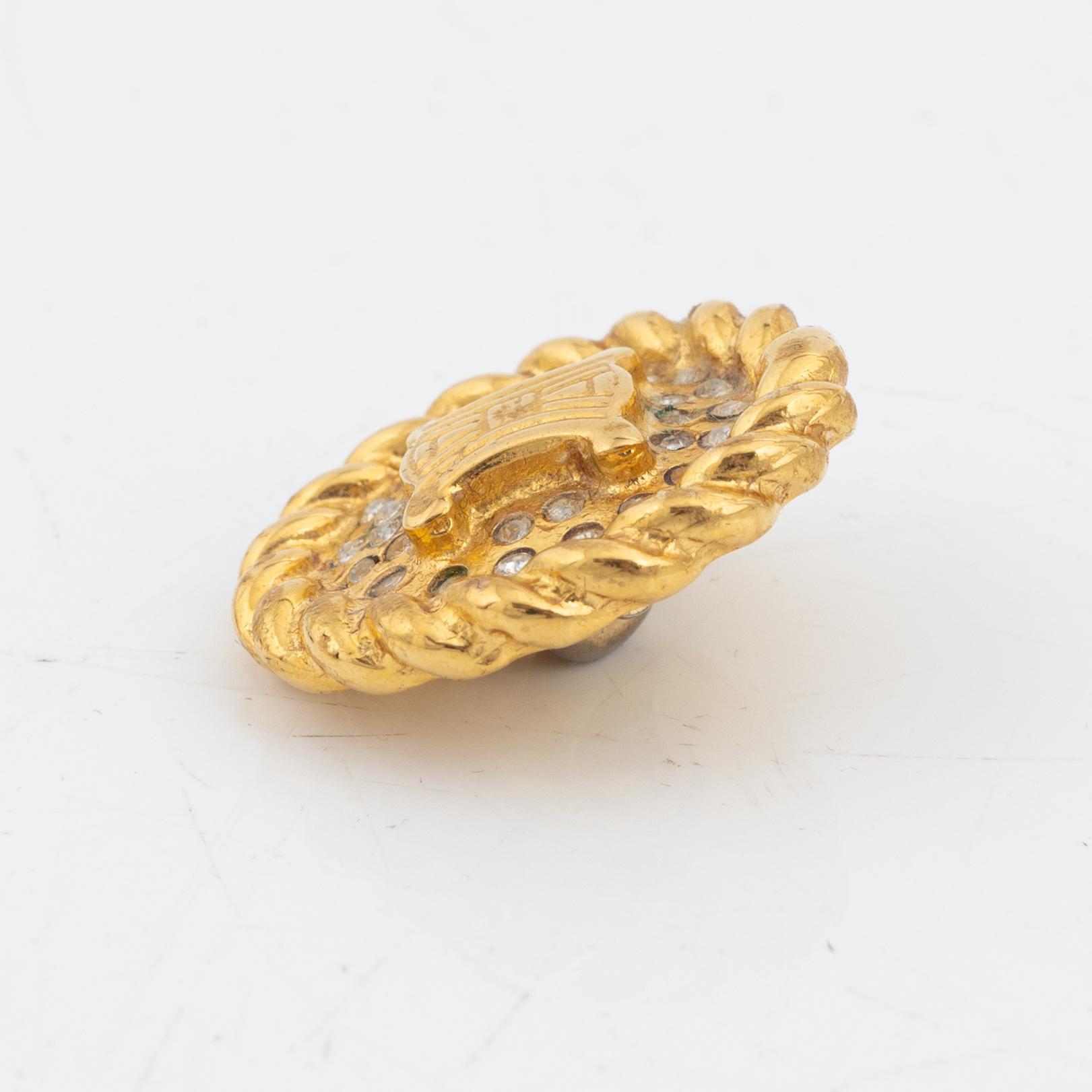 Céline, a set of four gold tone brooches.