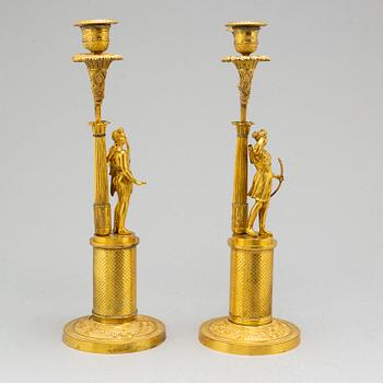 A pair of French Empire two-light gilt bronze candelabra, early 19th century.