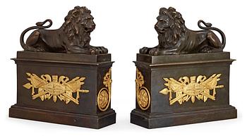 679. A pair of French Empire early 19th century gilt and patinated bronze chenets.