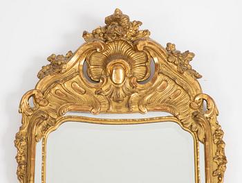 A Rococo style mirror and a console table, first half of the 20th Century.